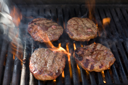 burgers smoking on a grill